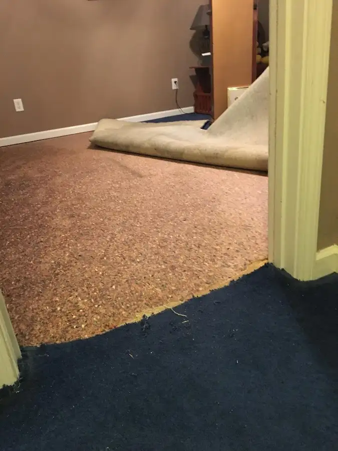 Carpet pad removal revealing water damage during Water Mitigation Services in Cramerton